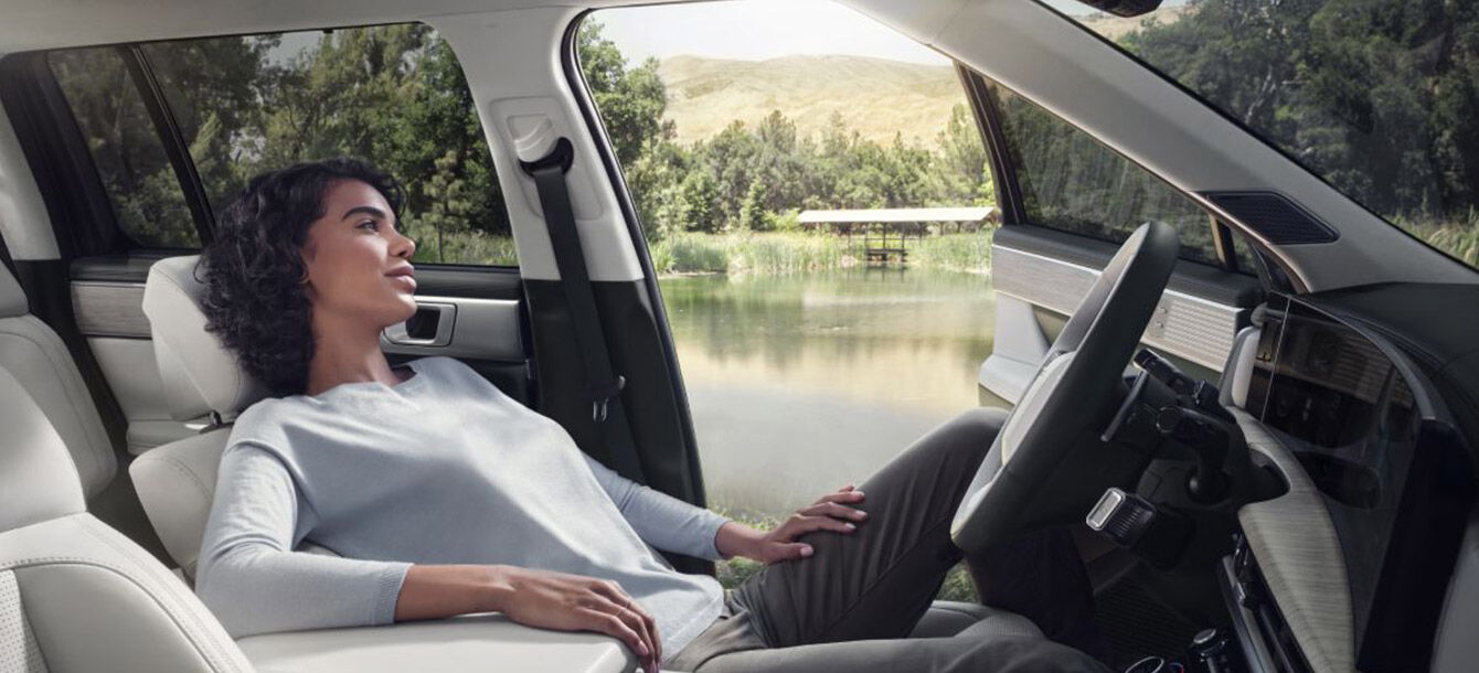 A woman relaxing in the spacious driver's seat