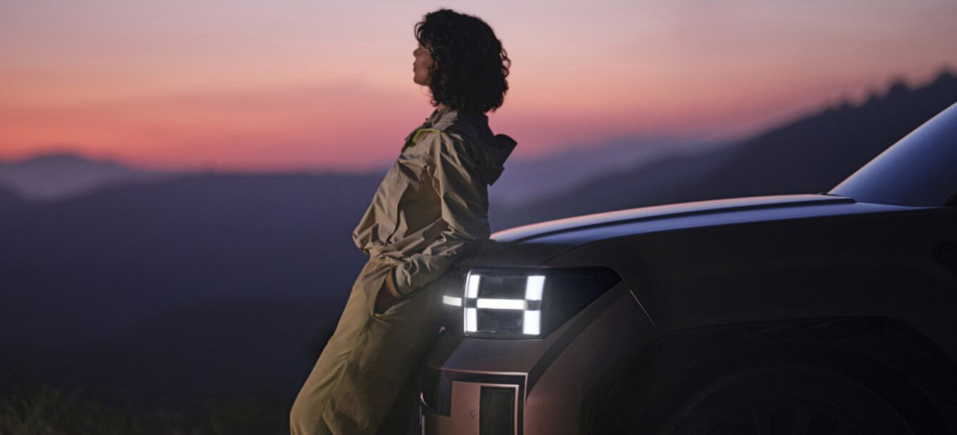 A woman leaning against a Santa Fe